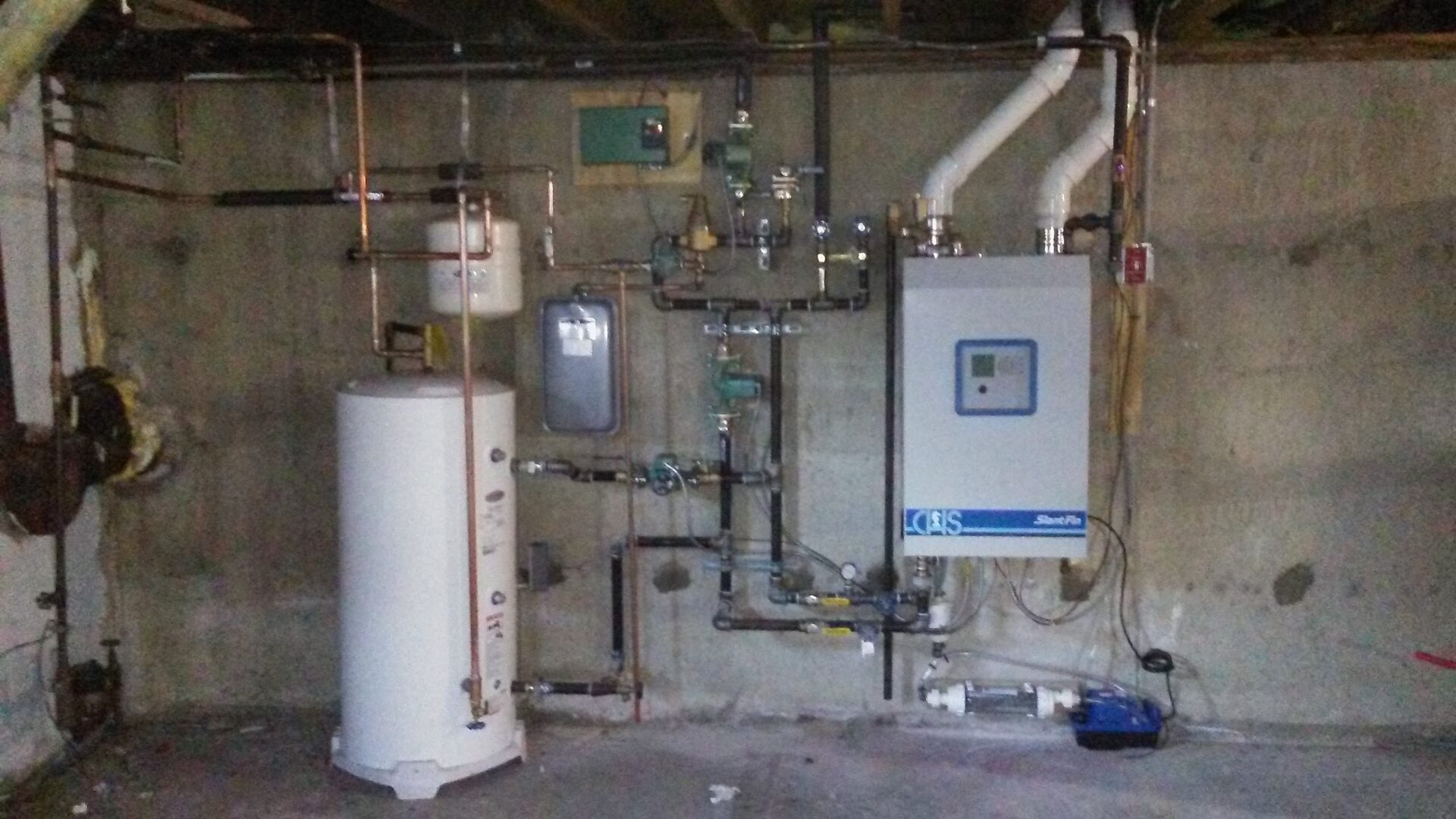 A room with pipes and water tanks in it